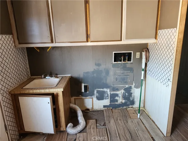 a kitchen with granite countertop a sink stove and cabinets