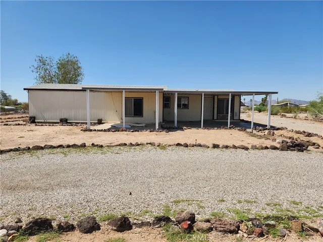 a view of large space with a wooden fence