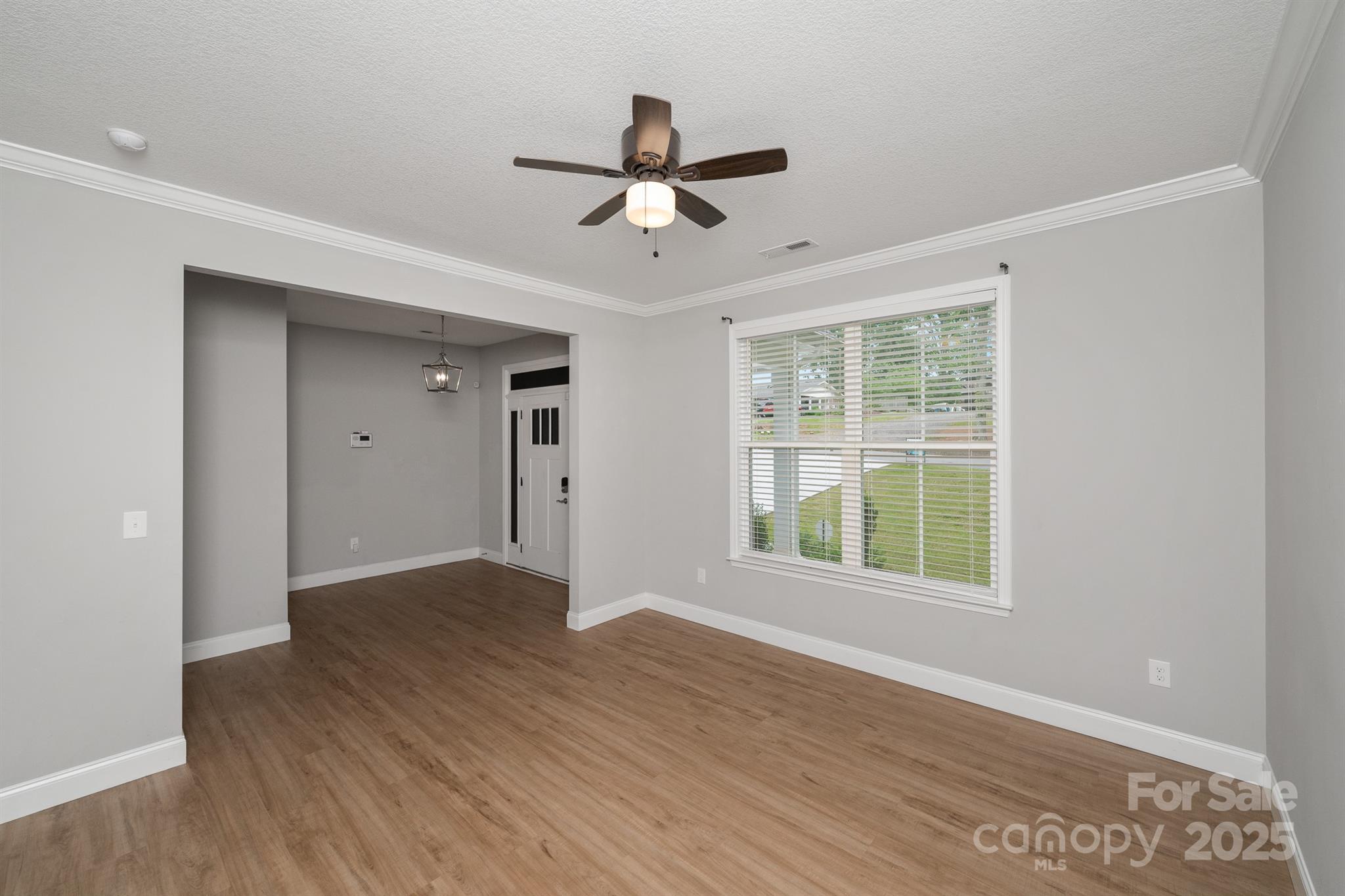 100 Holly Drive Duncan, SC 29334 - Photo 2 of 41 a view of an empty room with wooden floor and a window