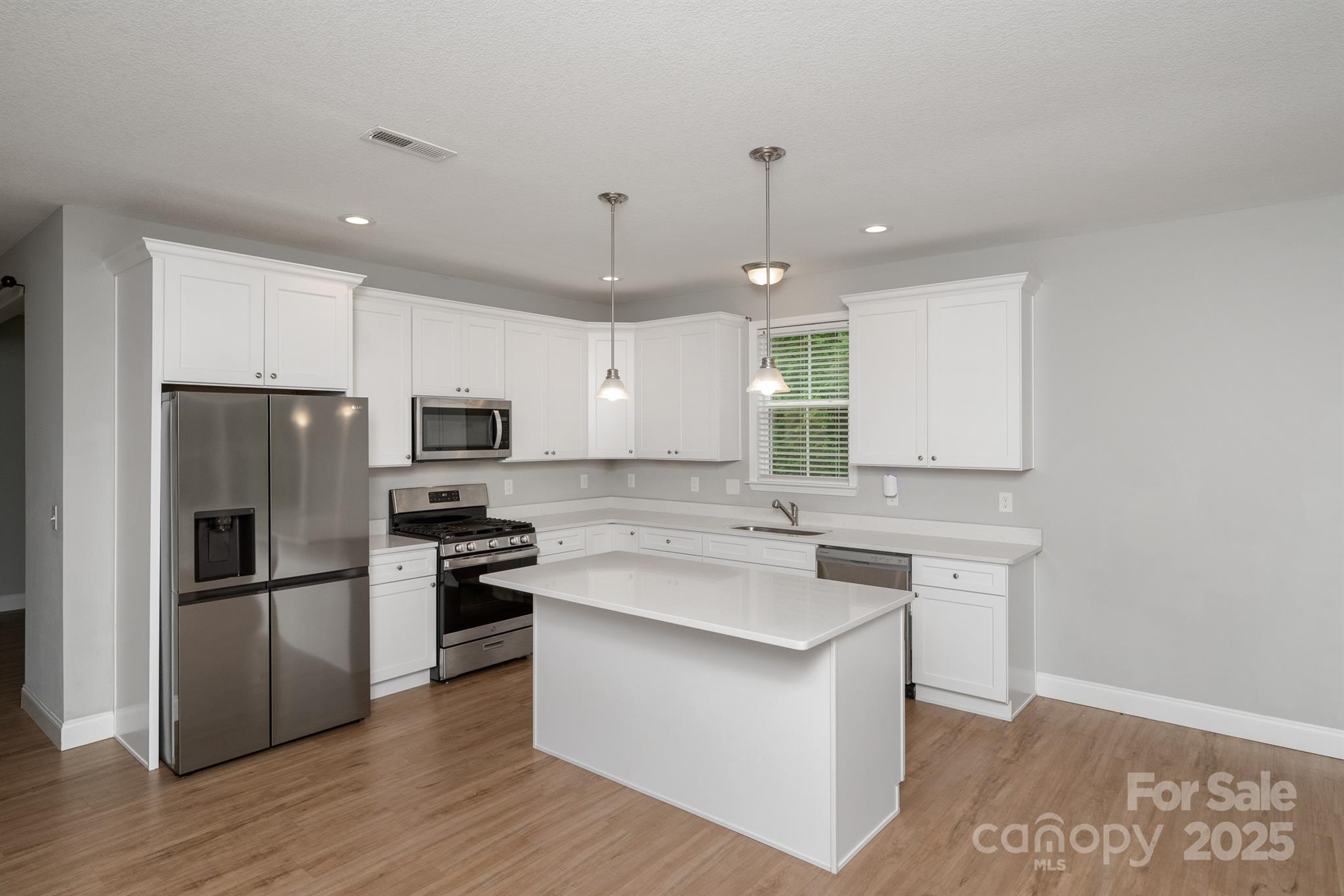 100 Holly Drive Duncan, SC 29334 - Photo 3 of 41 a kitchen with a refrigerator a sink and a stove top oven