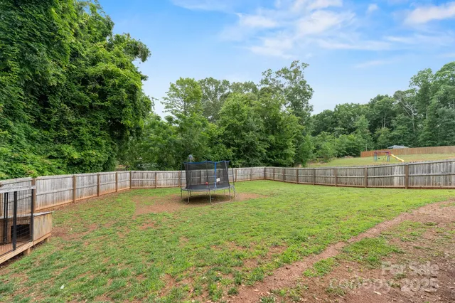 a swimming pool with a wooden fence