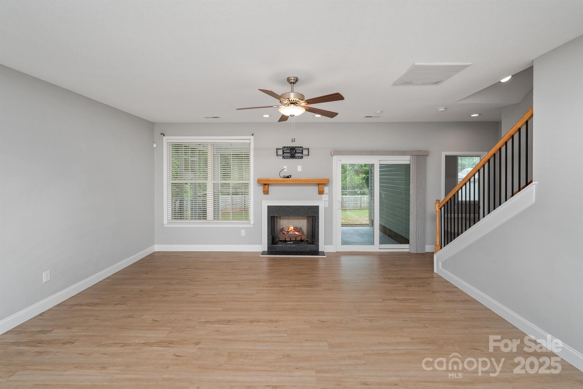 100 Holly Drive Duncan, SC 29334 - Photo 5 of 41 a view of a livingroom with a fireplace a ceiling fan and wooden floor