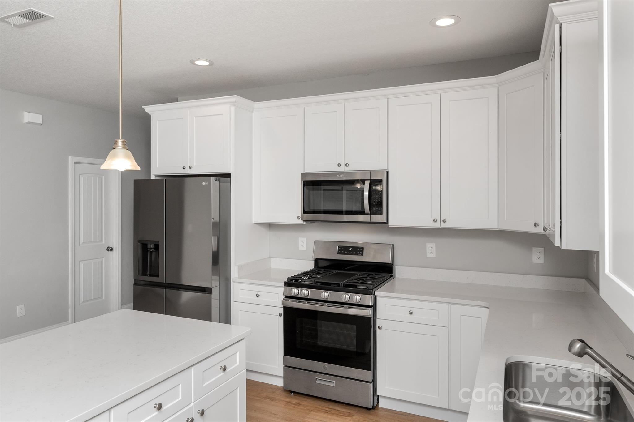 100 Holly Drive Duncan, SC 29334 - Photo 10 of 41 a kitchen with stainless steel appliances white cabinets and a refrigerator