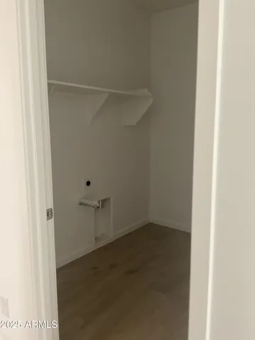 a view of a kitchen with white cabinets