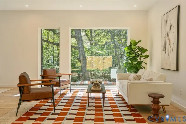 a living room with furniture and a potted plant
