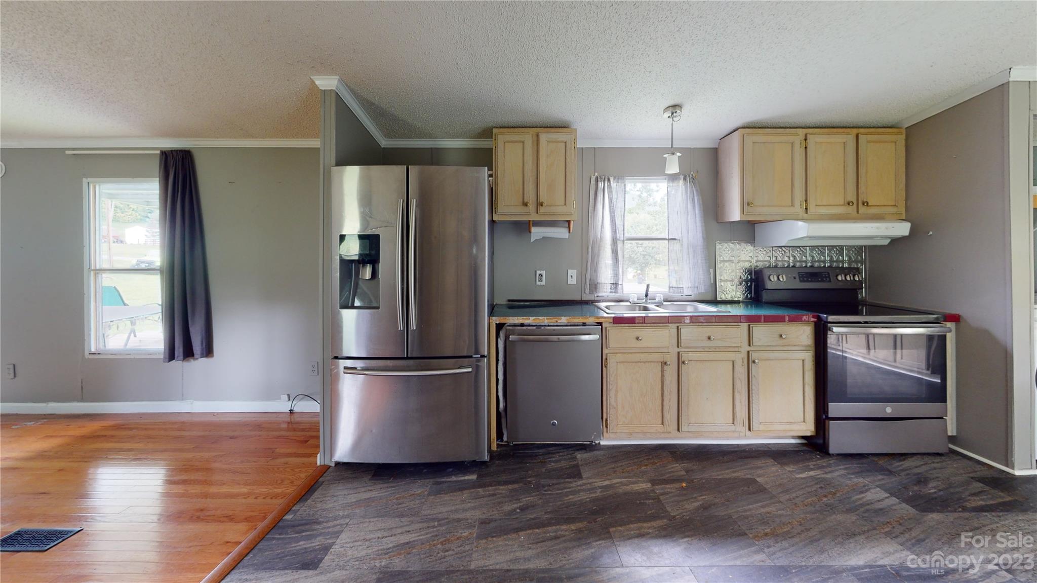 28 Thomas Lane Clyde, NC 28721 - Photo 4 of 9 a kitchen with a refrigerator sink and cabinets