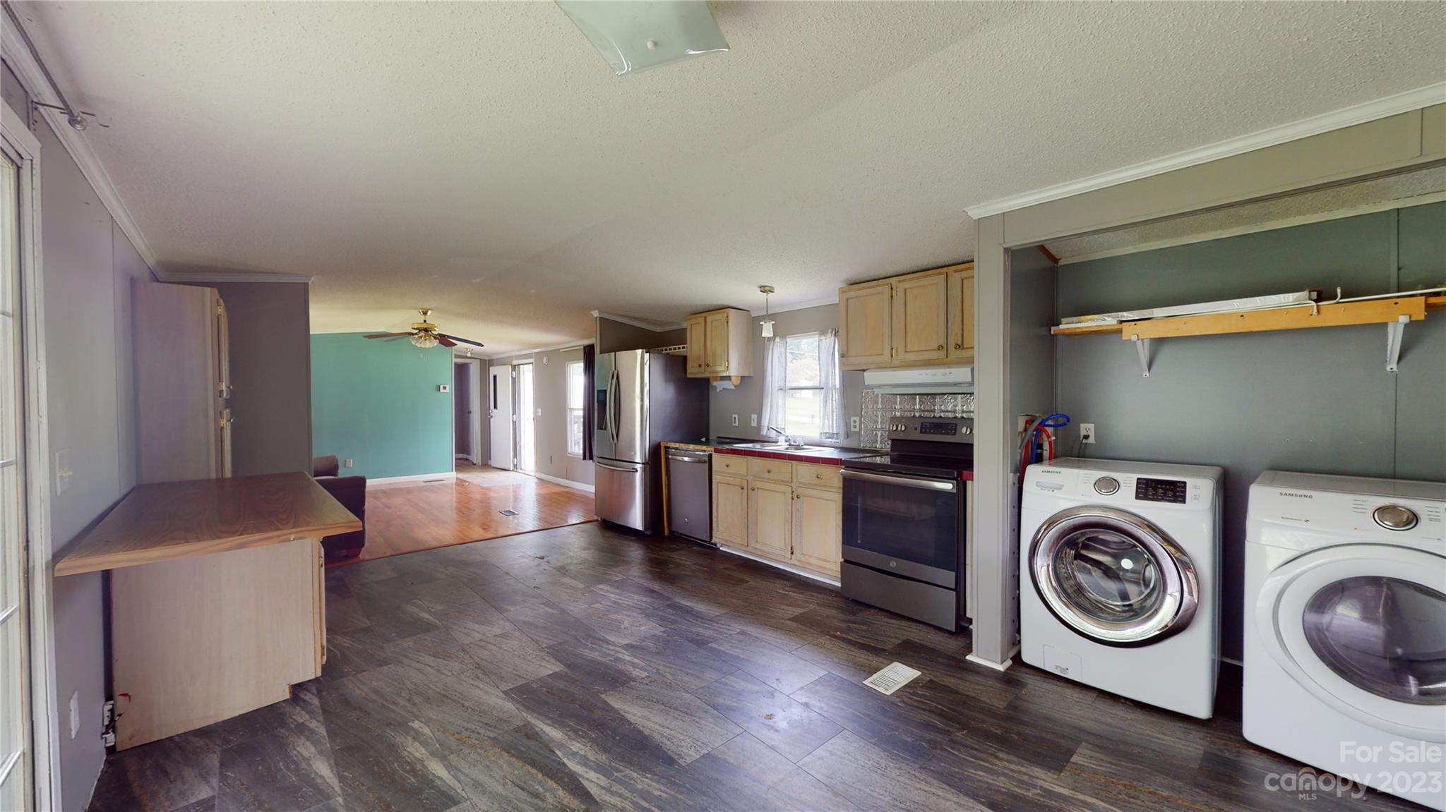 28 Thomas Lane Clyde, NC 28721 - Photo 5 of 9 a view of a kitchen with fridge and wooden floor
