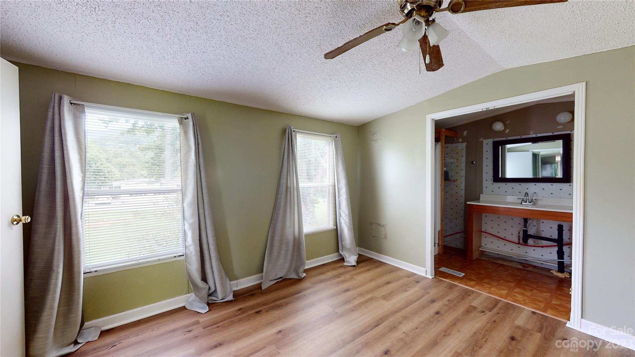 28 Thomas Lane Clyde, NC 28721 - Photo 7 of 9 a view of room with window and wooden floor