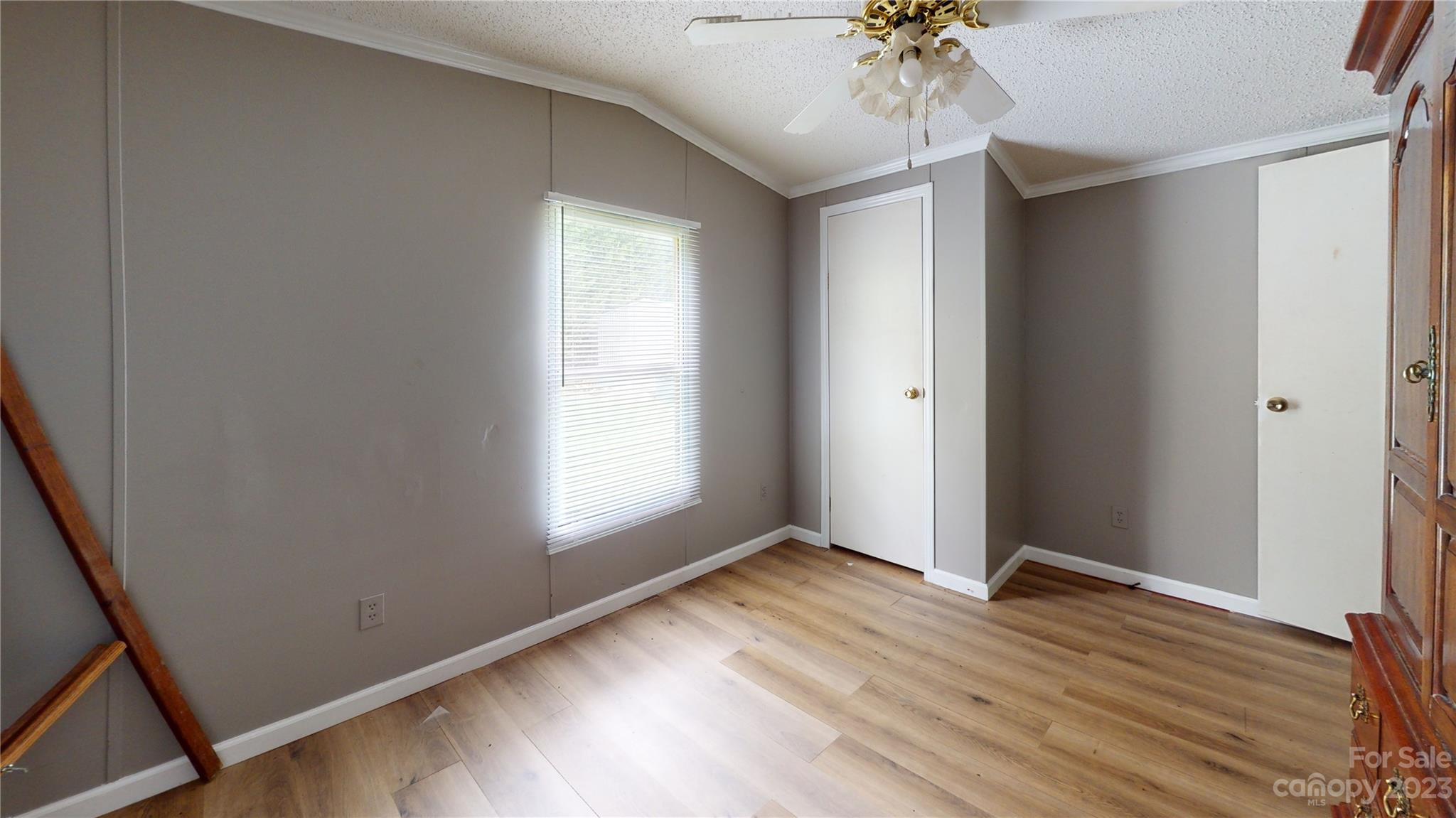 28 Thomas Lane Clyde, NC 28721 - Photo 9 of 9 an empty room with wooden floor and windows