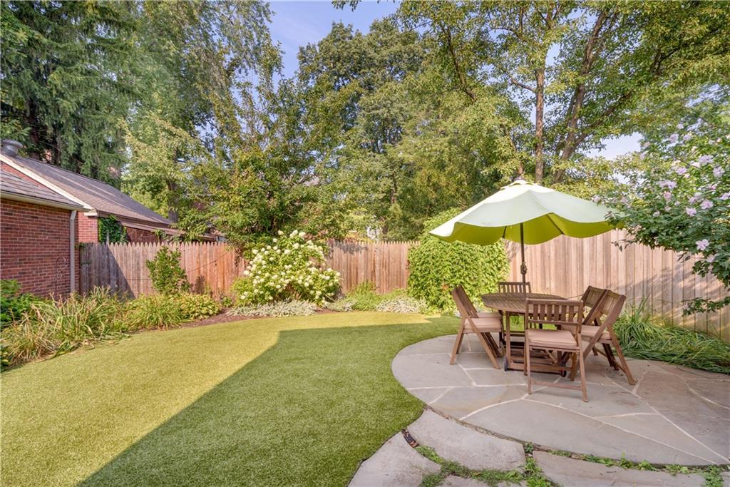 308 Maple Lane Sewickley, PA 15143 - Photo 3 of 25 a patio with a table and chairs under an umbrella