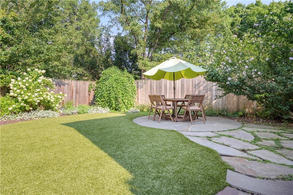 308 Maple Lane Sewickley, PA 15143 - Photo 5 of 25 a view of a backyard with table and chairs potted plants and a palm tree