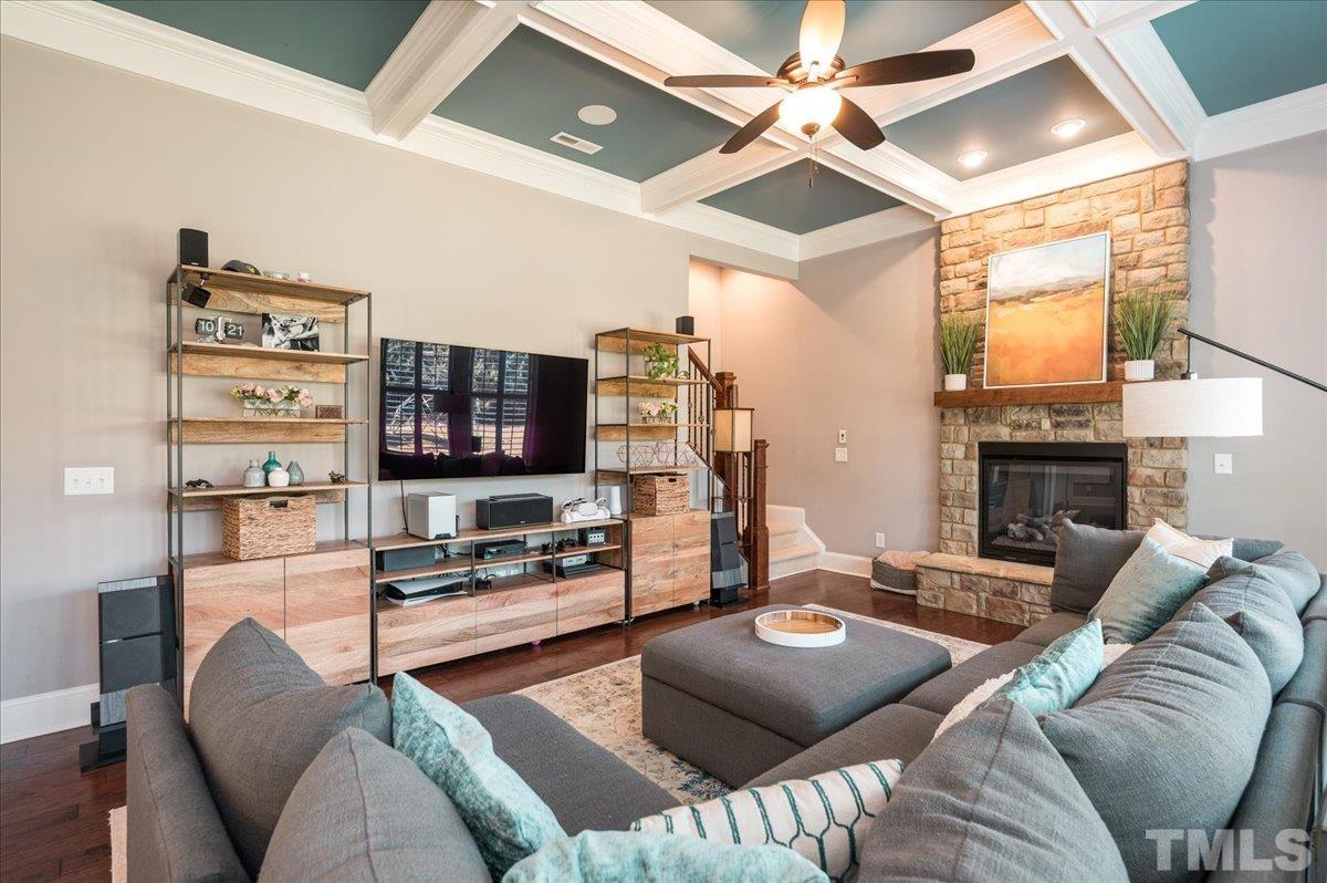 5100 Gansett Lane Raleigh, NC 27612 - Photo 12 of 39 a living room with furniture a flat screen tv and a fireplace