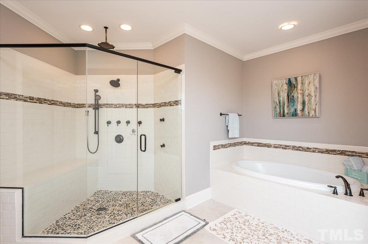5100 Gansett Lane Raleigh, NC 27612 - Photo 18 of 39 a bathroom with a bathtub and a shower