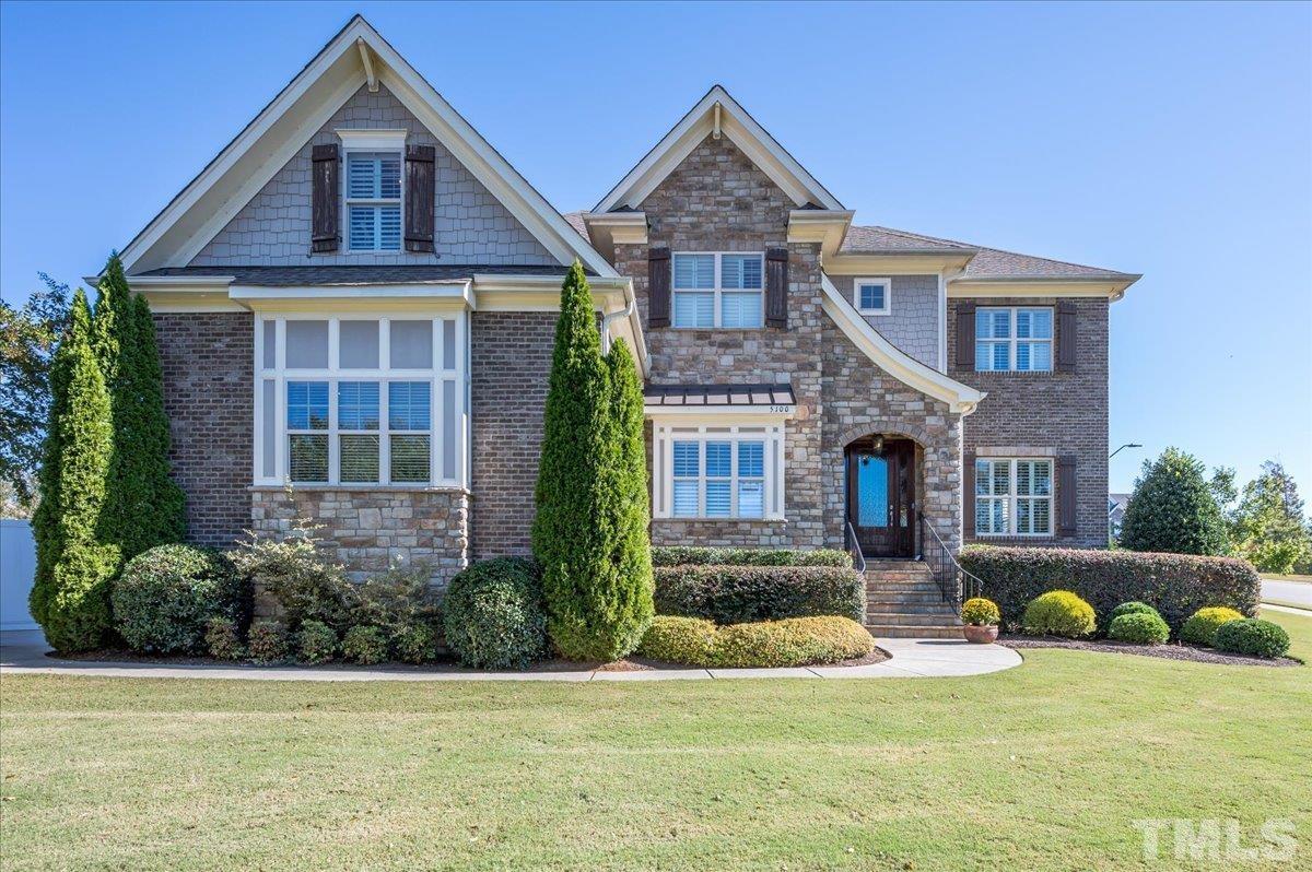 5100 Gansett Lane Raleigh, NC 27612 - Photo 2 of 39 a front view of a house with a yard and garage