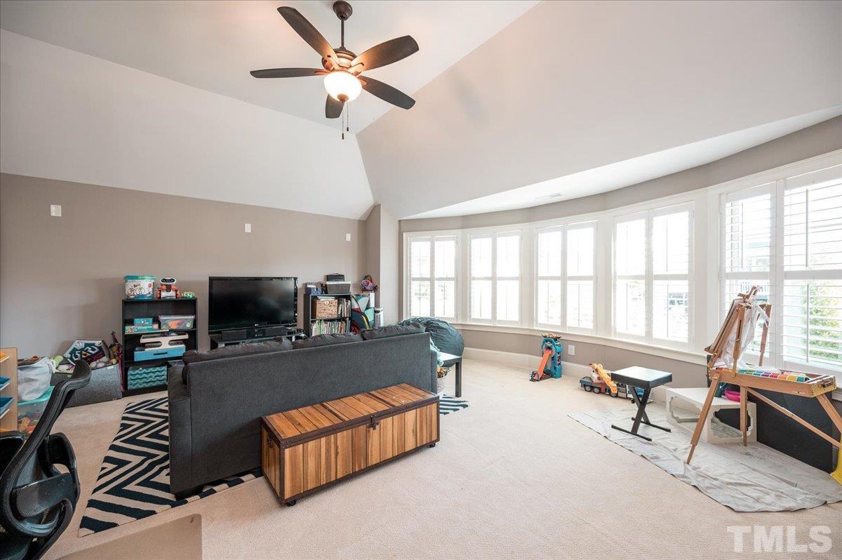5100 Gansett Lane Raleigh, NC 27612 - Photo 21 of 39 a living room with furniture and a flat screen tv