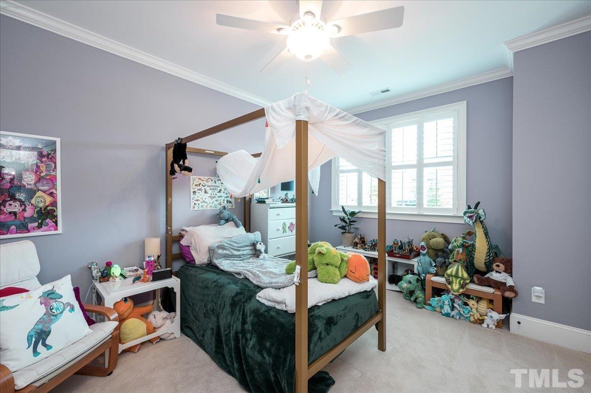 5100 Gansett Lane Raleigh, NC 27612 - Photo 25 of 39 a bedroom with bed a couch and a window