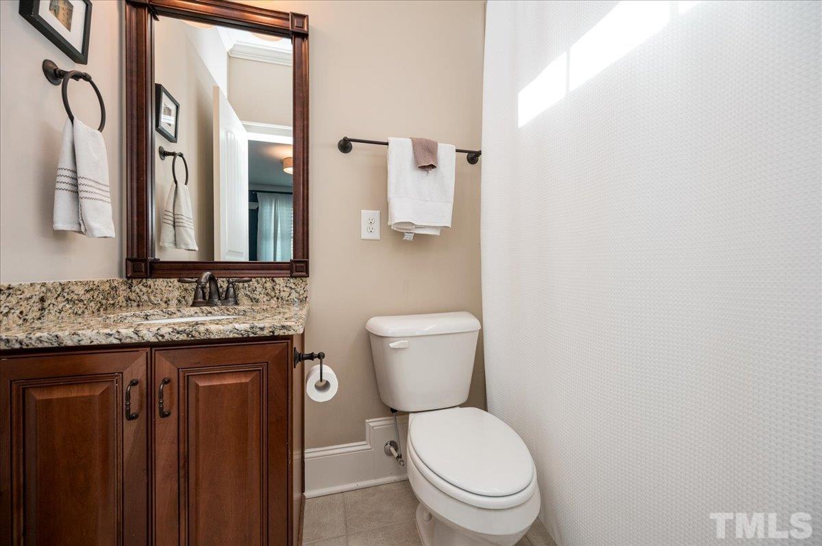 5100 Gansett Lane Raleigh, NC 27612 - Photo 26 of 39 a bathroom with a granite countertop toilet and a sink