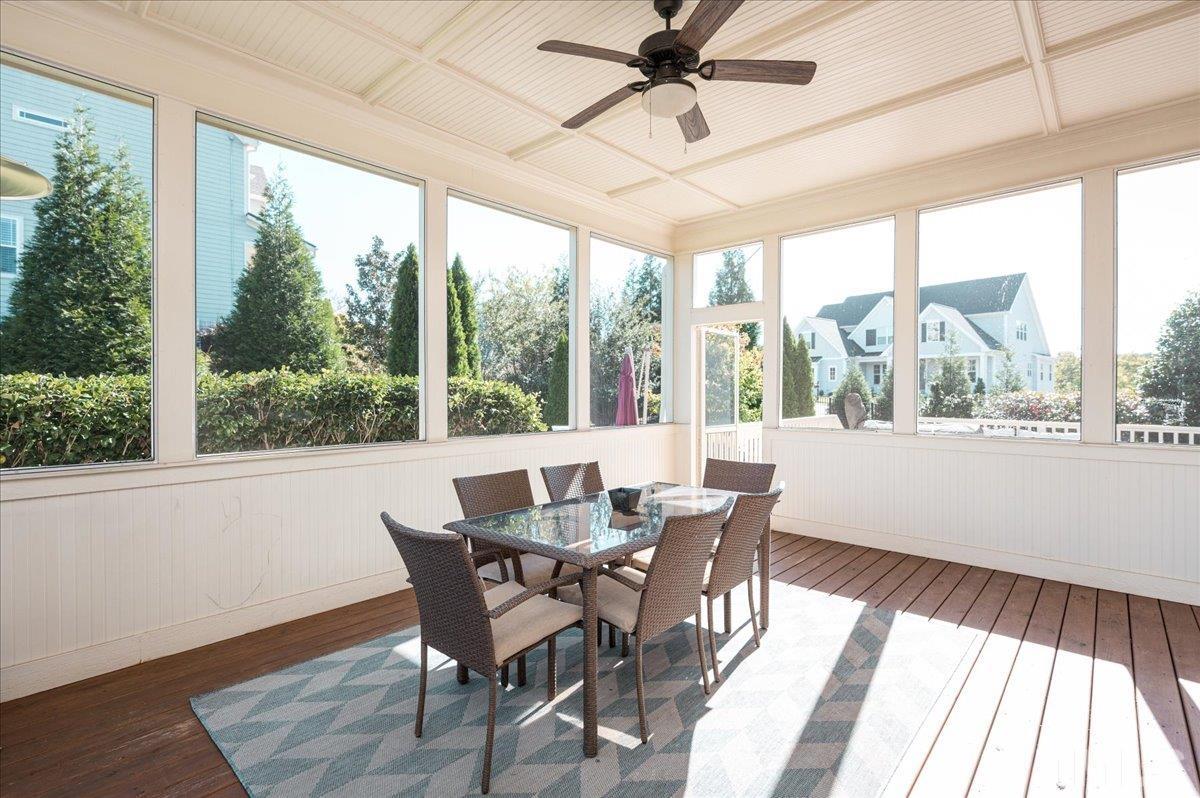 5100 Gansett Lane Raleigh, NC 27612 - Photo 28 of 39 a dining room with wooden floor a chandelier with a dining table and chairs