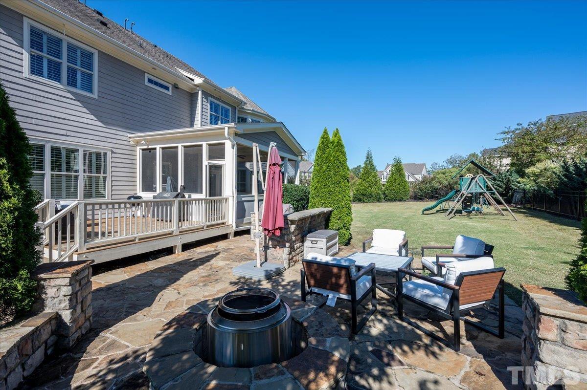 5100 Gansett Lane Raleigh, NC 27612 - Photo 31 of 39 a view of a patio with table and chairs with wooden floor and fence