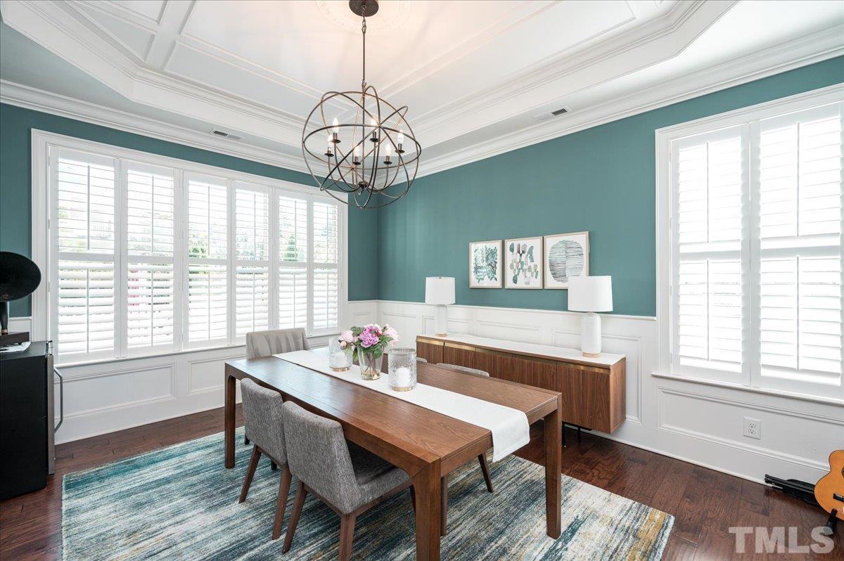 5100 Gansett Lane Raleigh, NC 27612 - Photo 7 of 39 a view of a dining room with furniture wooden floor and chandelier