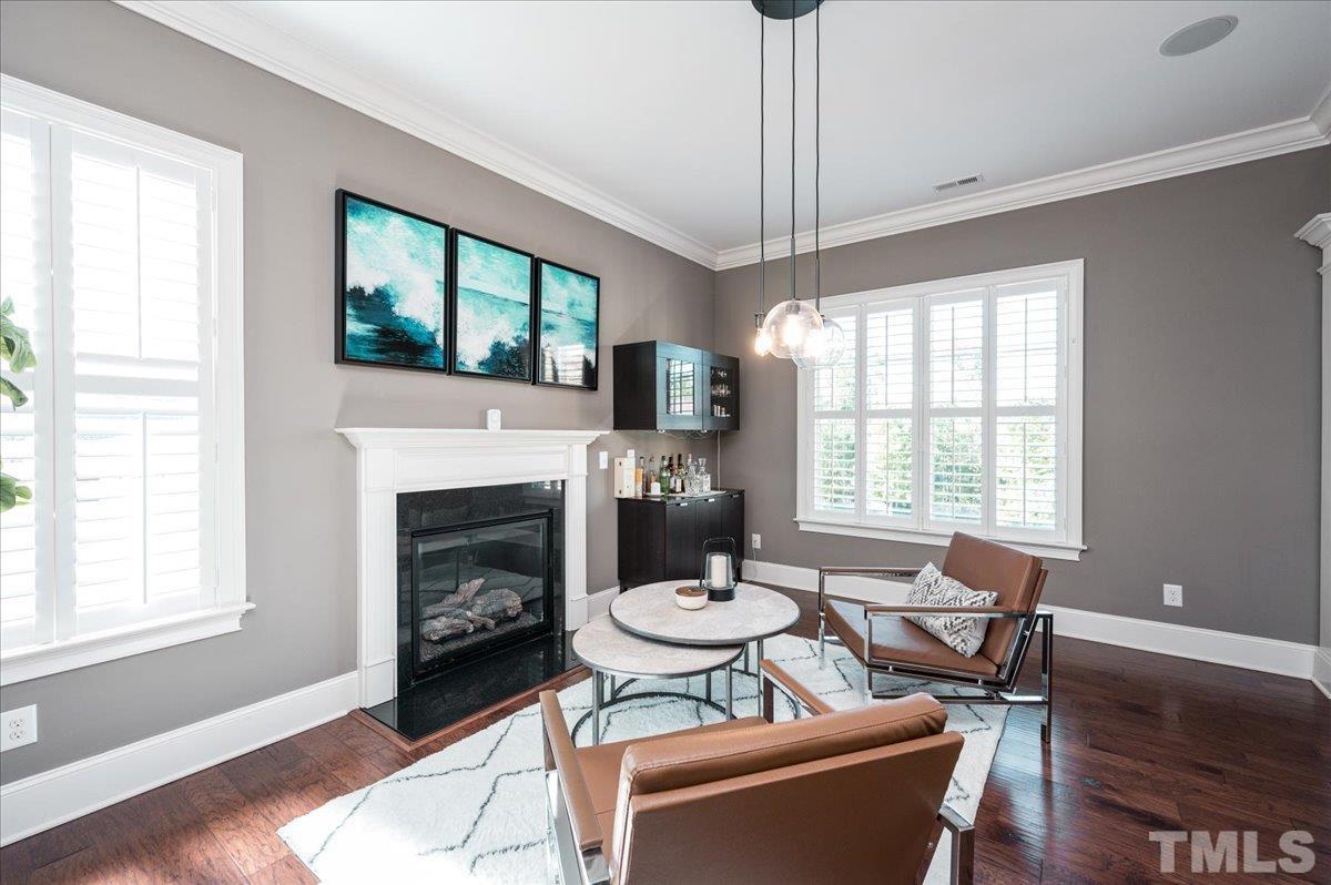 5100 Gansett Lane Raleigh, NC 27612 - Photo 9 of 39 a living room with furniture a window and a fireplace