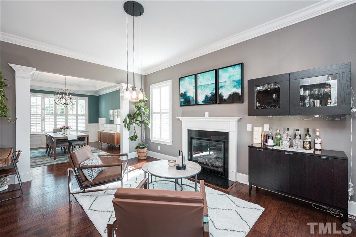 5100 Gansett Lane Raleigh, NC 27612 - Photo 10 of 39 a living room with furniture a flat screen tv and a fireplace