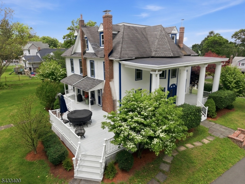 61 New Street Hampton, NJ 08827 - Photo 37 of 45 a view of a white house with a yard potted plants and a table