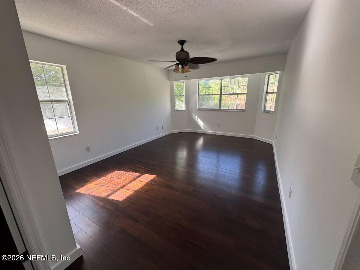 543 Ray Edwards Road St. Augustine, FL 32086 - Photo 13 of 19 wooden floor in an empty room with a window