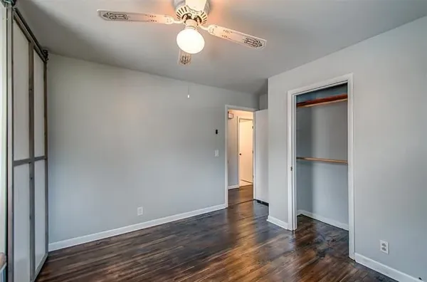 a view of an empty room with wooden floor
