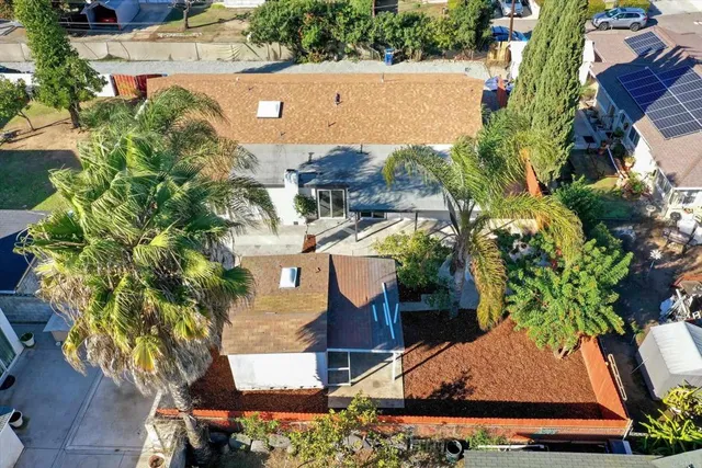 an aerial view of residential houses with outdoor space
