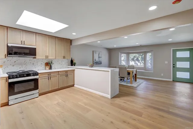 an empty room with ceiling fan and window