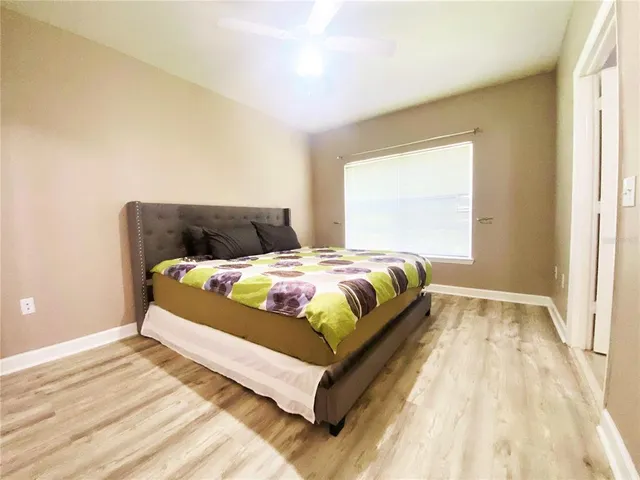 a bedroom with a bed and window