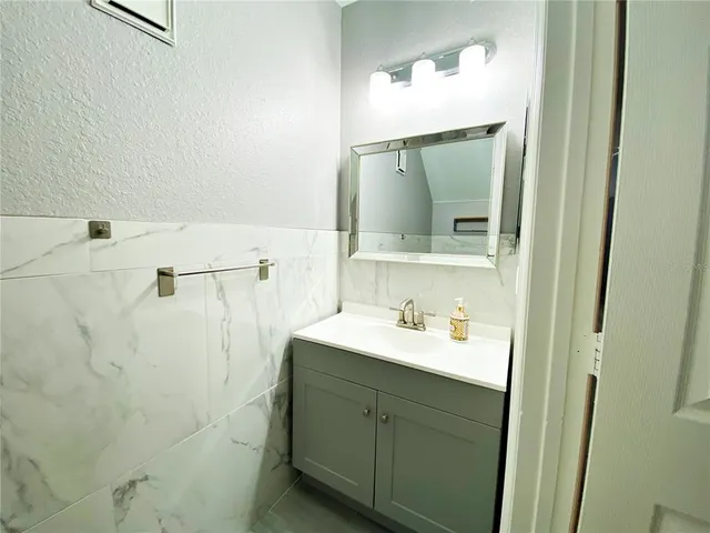 a bathroom with a sink vanity and mirror