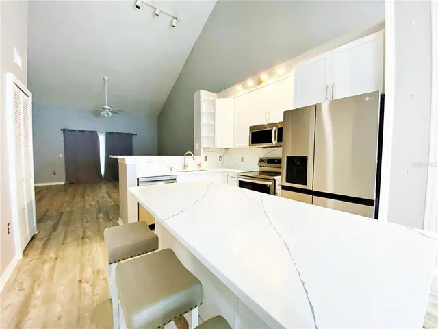 a kitchen with stainless steel appliances a refrigerator and a stove