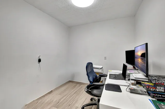 a workspace with furniture and a flat screen tv