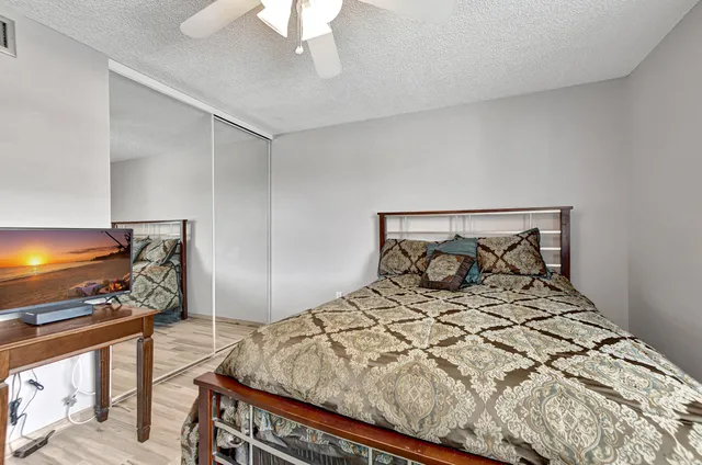 a bedroom with a bed and a flat screen tv