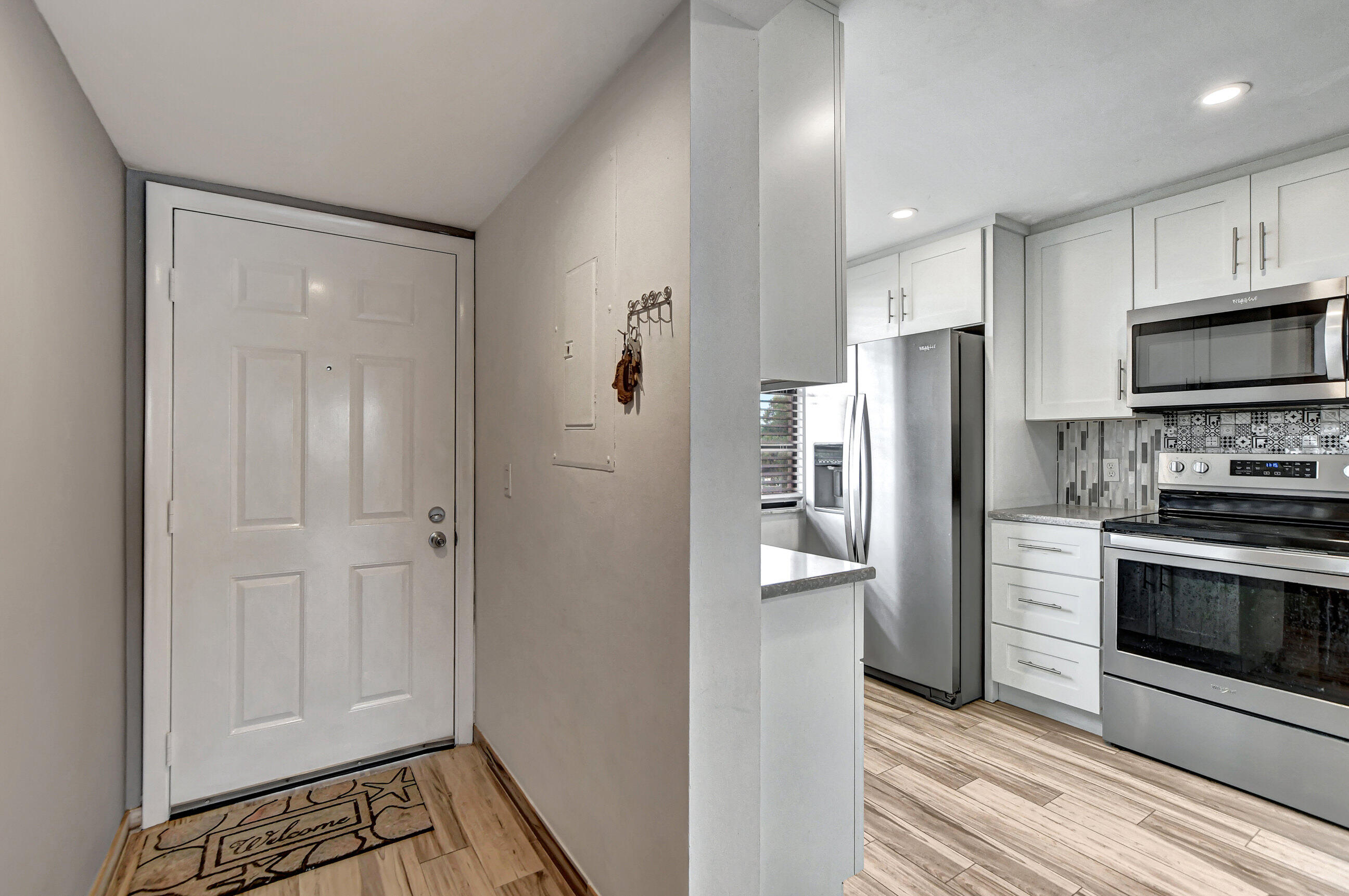 6025 Balboa Circle, Unit 304 Boca Raton, FL 33433 - Photo 2 of 38 a kitchen with stainless steel appliances granite countertop a refrigerator and a stove top oven