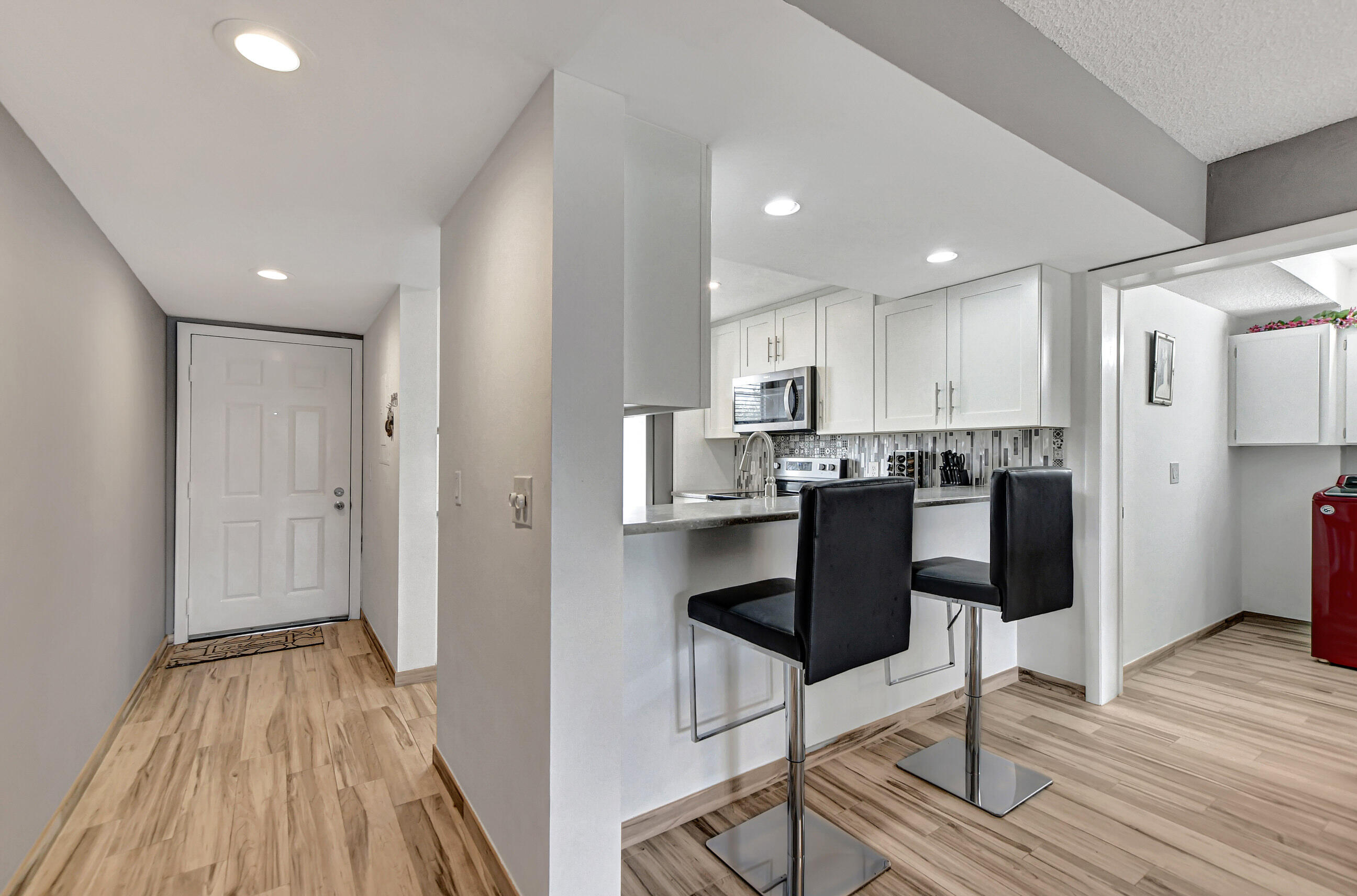 6025 Balboa Circle, Unit 304 Boca Raton, FL 33433 - Photo 3 of 38 a kitchen with a table and chairs in it