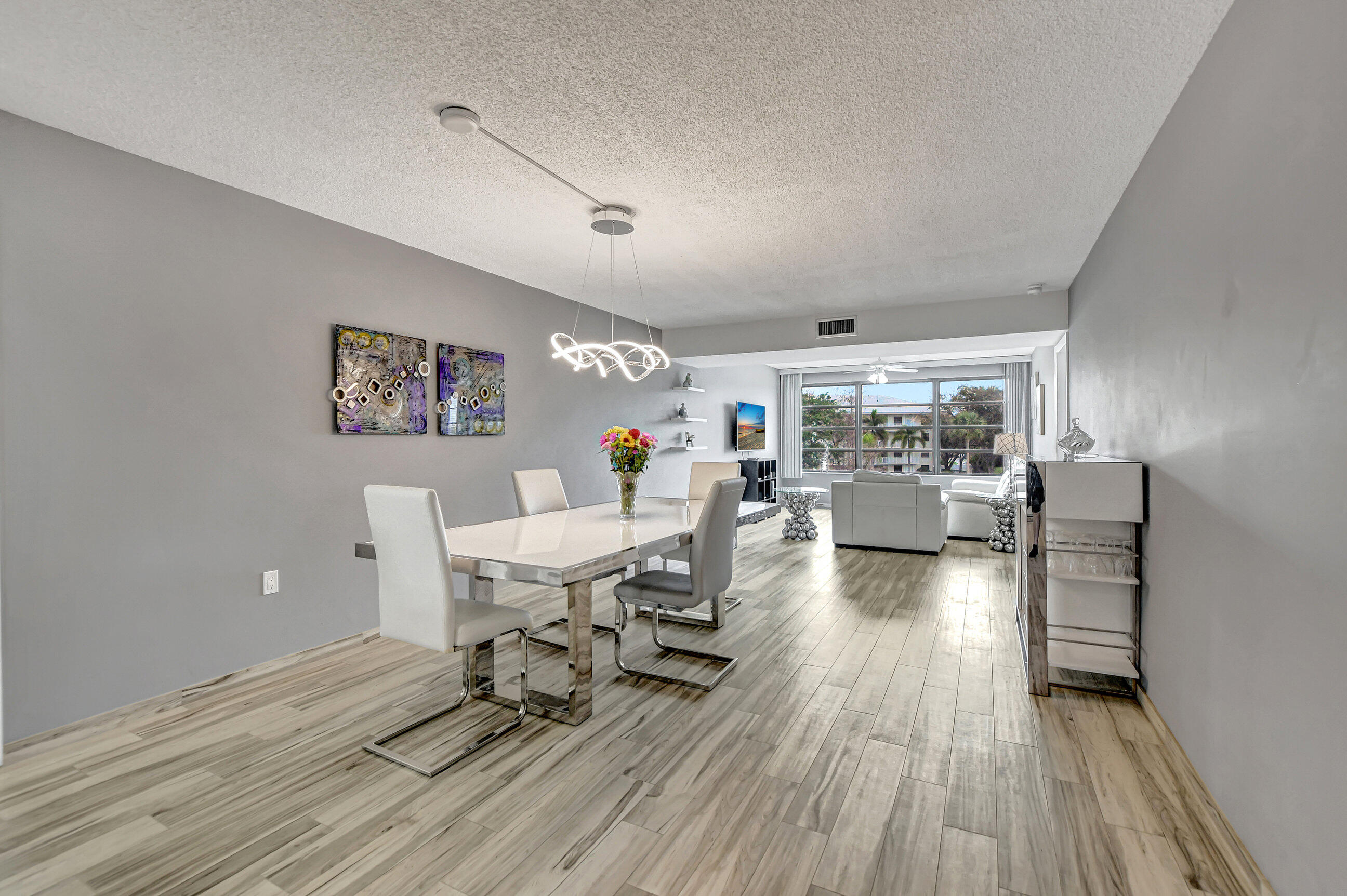 6025 Balboa Circle, Unit 304 Boca Raton, FL 33433 - Photo 9 of 38 a living room with furniture and a wooden floor