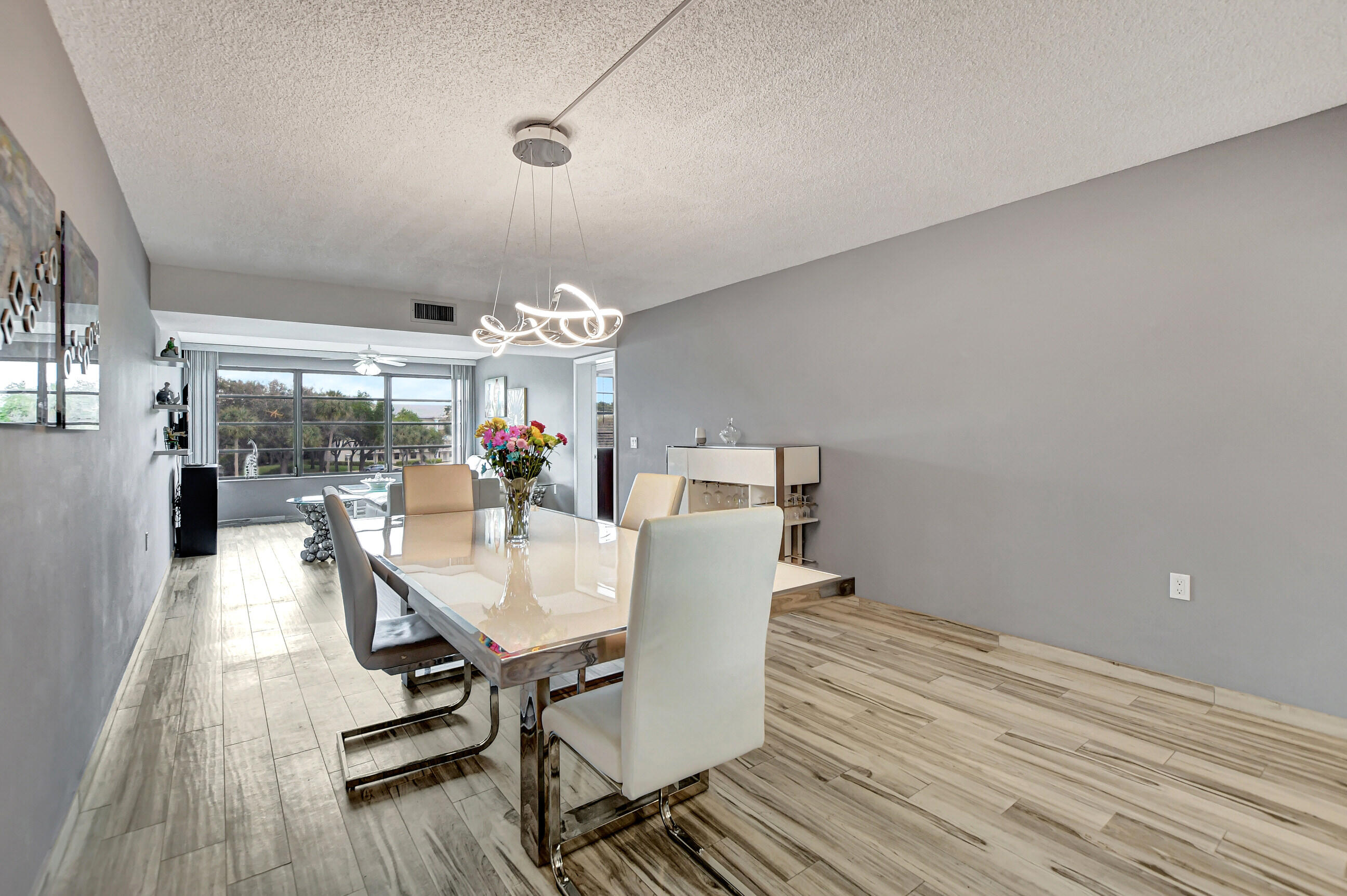 6025 Balboa Circle, Unit 304 Boca Raton, FL 33433 - Photo 10 of 38 a dining room with furniture and wooden floor