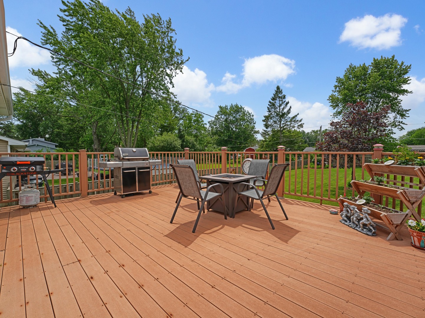 58 South Beck Road Lindenhurst, IL 60046 - Photo 32 of 37 a view of a roof deck with table and chairs a barbeque with wooden floor and fence