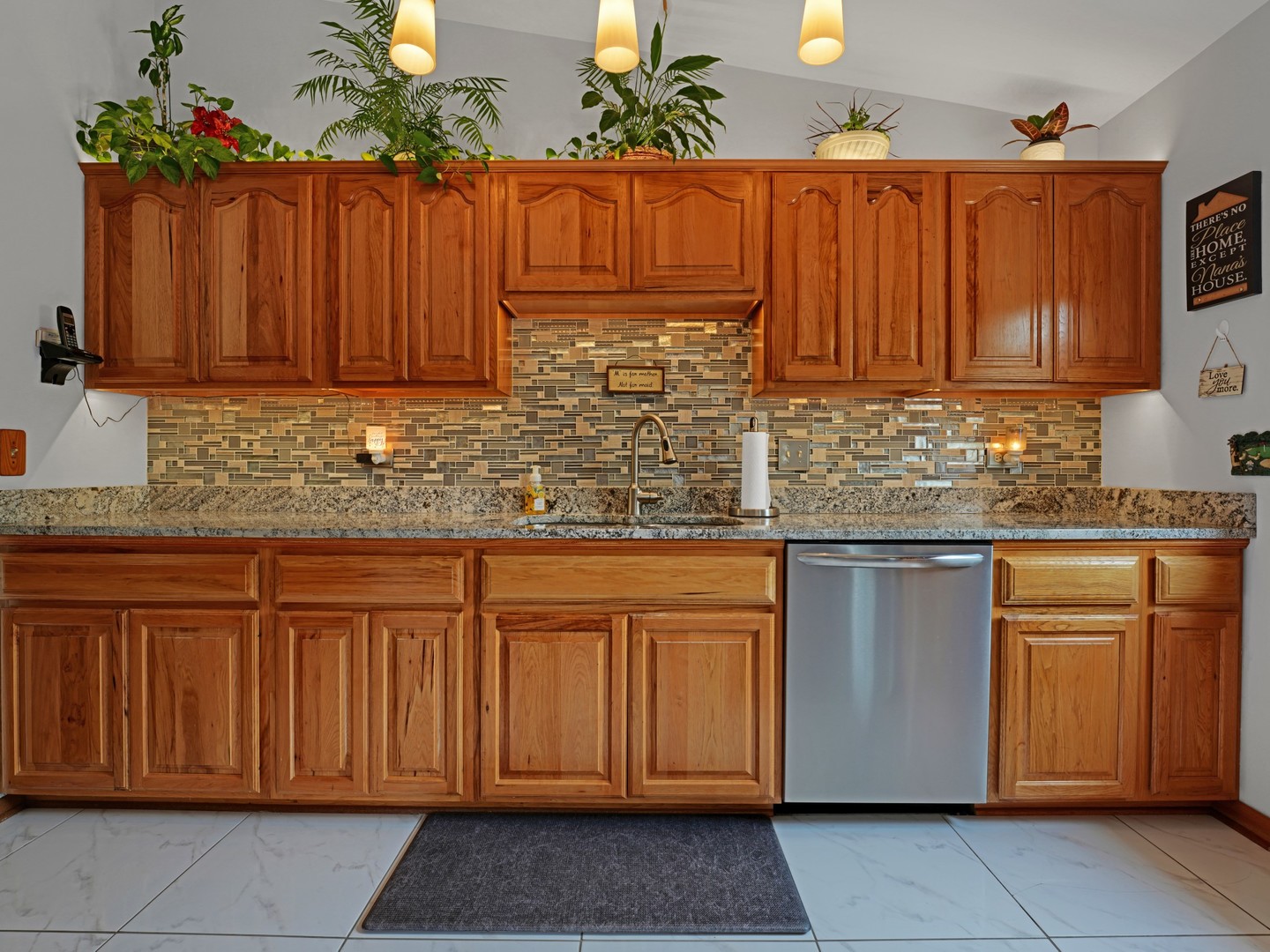 58 South Beck Road Lindenhurst, IL 60046 - Photo 9 of 37 a kitchen with stainless steel appliances granite countertop a sink and cabinets