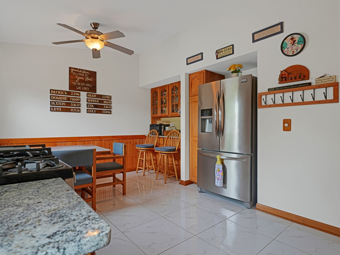 58 South Beck Road Lindenhurst, IL 60046 - Photo 10 of 37 a kitchen with stainless steel appliances granite countertop a refrigerator and a stove top oven