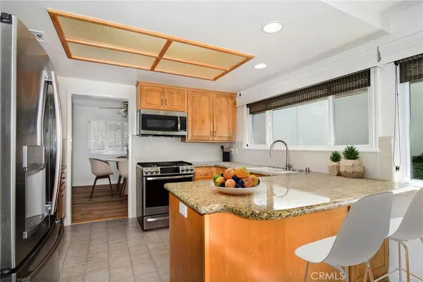 a kitchen with a stove a sink and a refrigerator