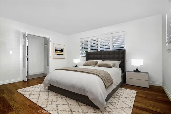a bedroom with a white bed and a couch