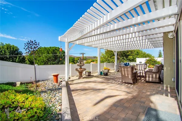 a view of a patio with table and chairs potted plants