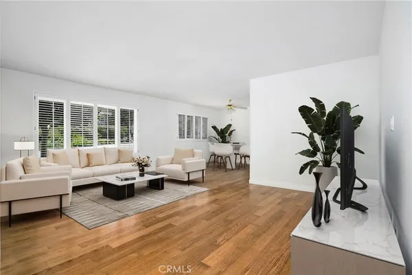 a living room with furniture and a potted plant