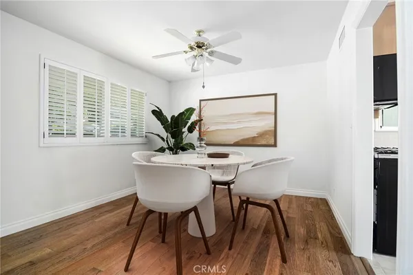 a workspace with furniture wooden floor and a window