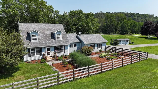 an aerial view of a house having patio with a garden