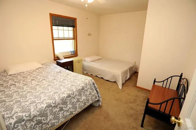 a bedroom with two beds and a window